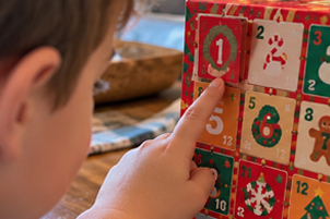 Child finding door number 1 on the advent calendar